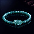 Blue green jade lotus bracelet worn by woman