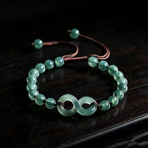 Blue green jade infinity bracelet worn on wrist