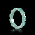 Pale green jadeite peach blossom ring worn by woman