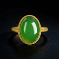 Large oval vivid green jadeite ring with gold-tone setting
