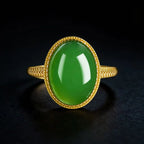 Large oval vivid green jadeite ring with gold-tone setting